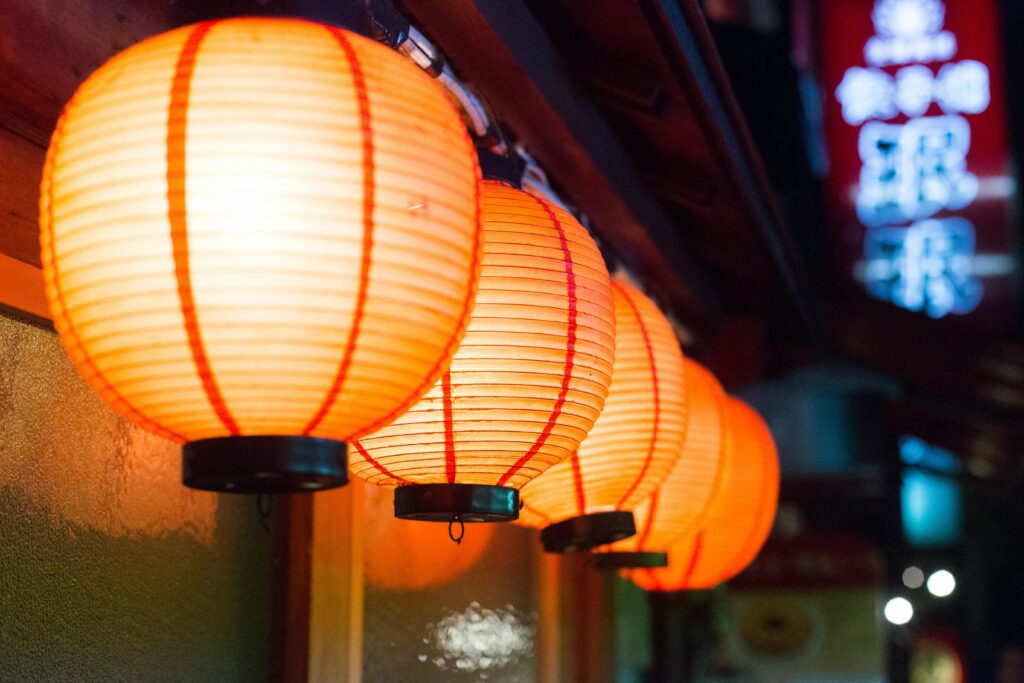 Close-up of illuminated Japanese paper lanterns in an outdoor setting in Nagawa, Nagano, Japan.