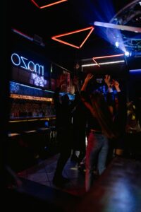 Vibrant nightclub with people dancing under neon lights, perfect for nightlife themes.